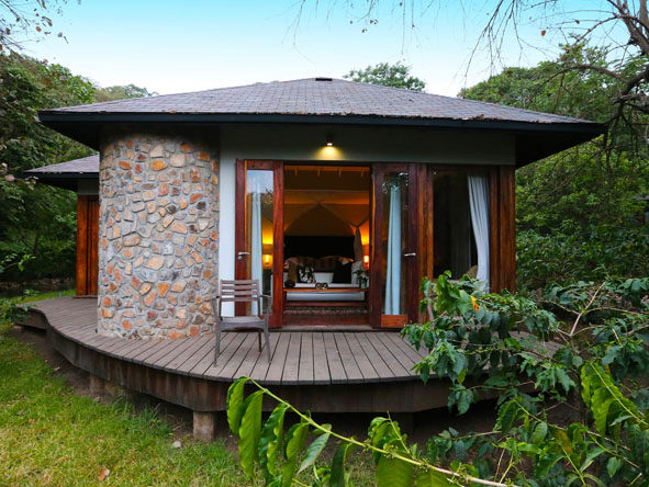 Private Lake Duluti Lodge chalet with wooden deck surrounded by greenery